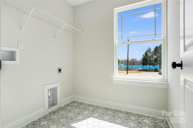 laundry area with laundry area, electric dryer hookup, and baseboards