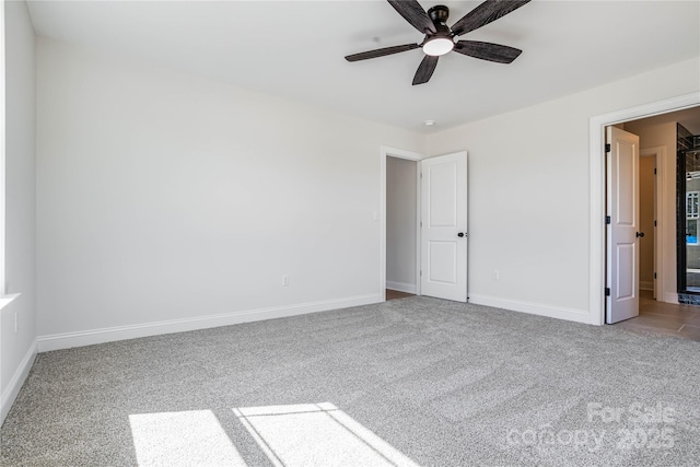 unfurnished bedroom with baseboards, carpet floors, and a ceiling fan