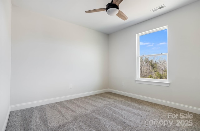 spare room featuring visible vents, baseboards, carpet, and ceiling fan