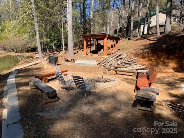 view of yard with a fire pit