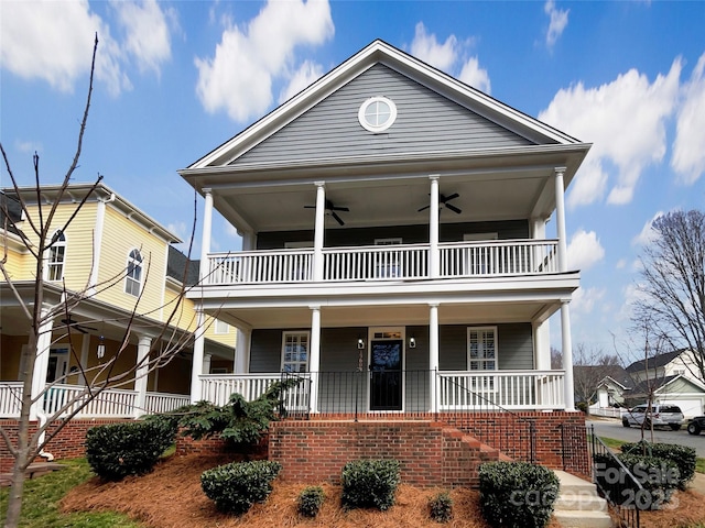 view of front of home with stairway, a balcony, covered porch, and ceiling fan