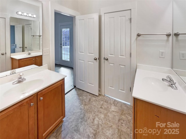 bathroom with two vanities and a sink