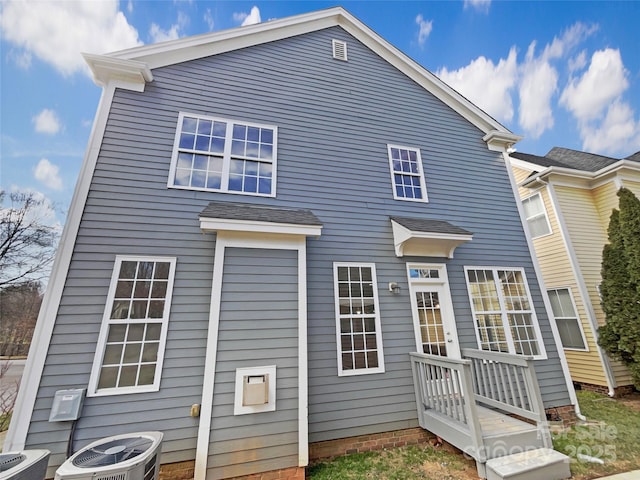 rear view of property featuring central AC