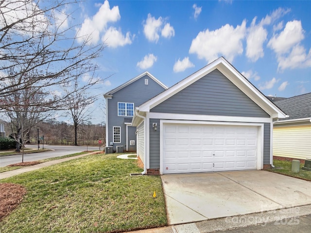 view of front of property with an attached garage, cooling unit, concrete driveway, and a front lawn