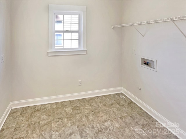 clothes washing area with baseboards, washer hookup, and laundry area