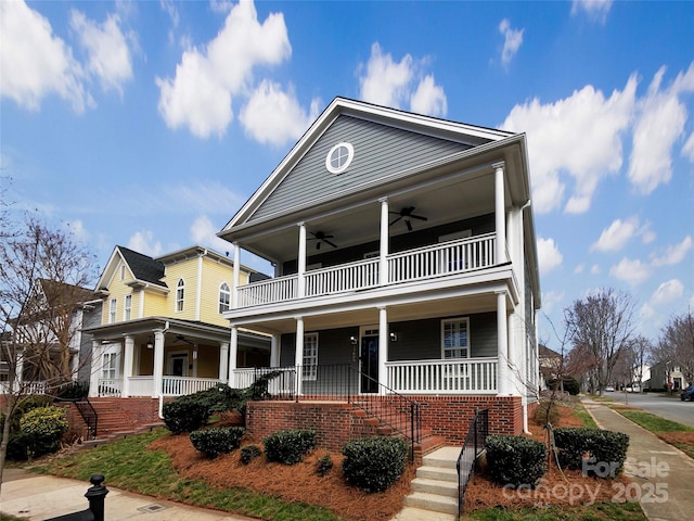 view of front of house with a porch, stairway, and a ceiling fan