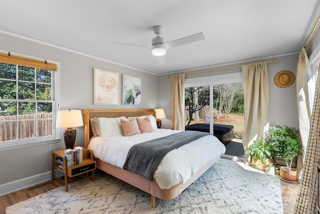 bedroom featuring baseboards, a ceiling fan, wood finished floors, and crown molding