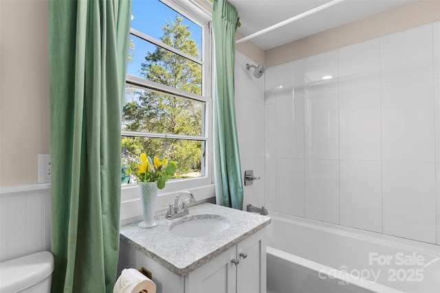 full bathroom with toilet, vanity, and shower / bath combination with curtain