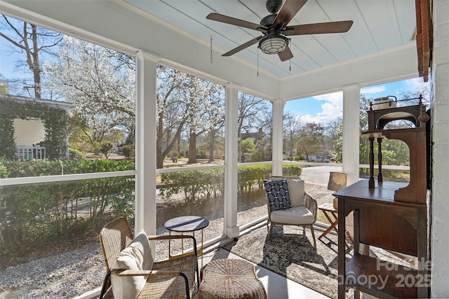 sunroom / solarium with a wealth of natural light and a ceiling fan