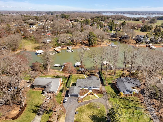 drone / aerial view featuring a residential view and a water view