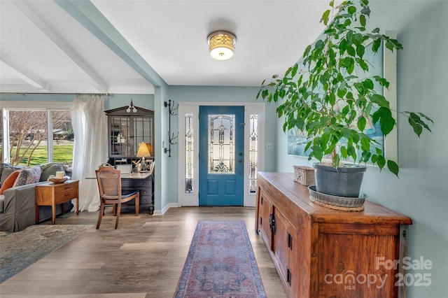 foyer with beam ceiling and wood finished floors