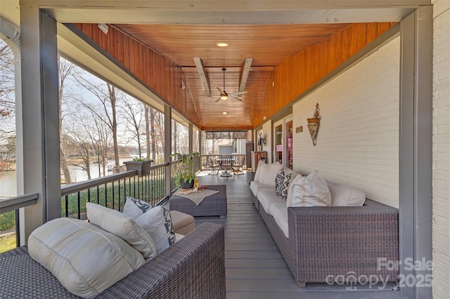 sunroom with wooden ceiling, lofted ceiling, and a ceiling fan