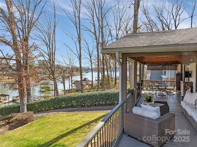 deck with outdoor dining space, a lawn, a water view, and an outdoor hangout area