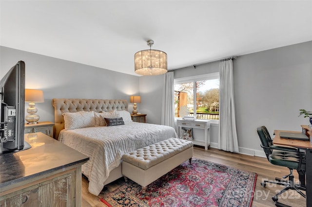 bedroom featuring light wood-type flooring and baseboards