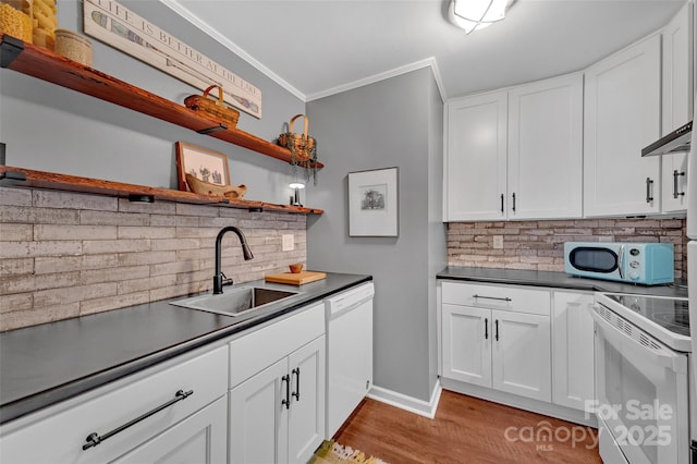 kitchen featuring open shelves, dark countertops, white appliances, and a sink