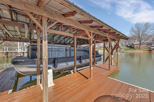 dock area with a water view and boat lift