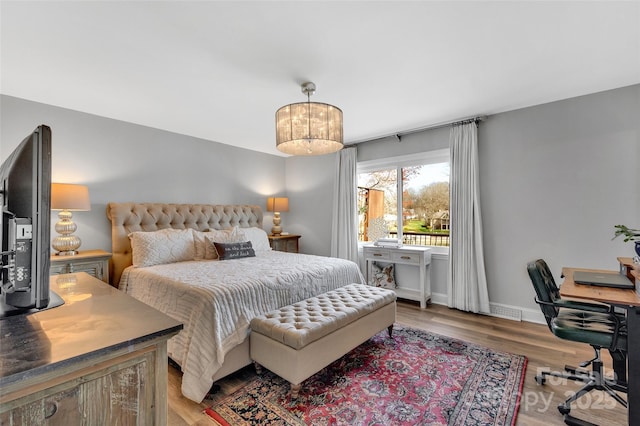 bedroom featuring baseboards and light wood finished floors
