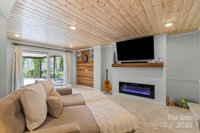 living area with a glass covered fireplace, recessed lighting, wooden ceiling, carpet flooring, and wood walls