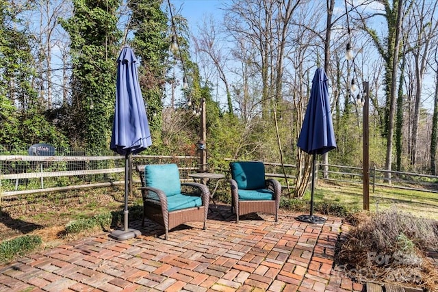 view of patio featuring fence