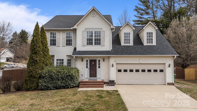 traditional home with a garage, a shingled roof, driveway, and fence