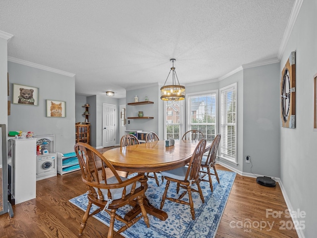 dining room featuring a chandelier, a textured ceiling, baseboards, and wood finished floors