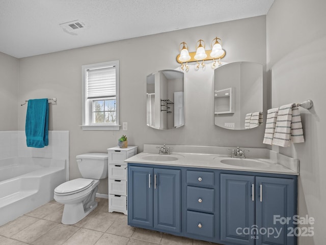 full bath with a bath, double vanity, a textured ceiling, and a sink