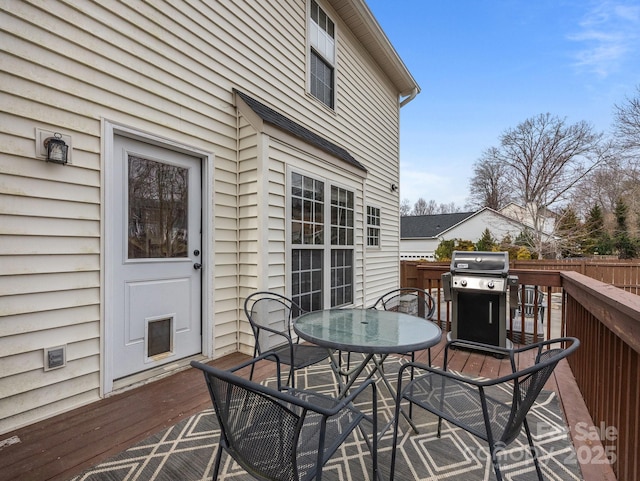 deck featuring a grill, outdoor dining space, and fence