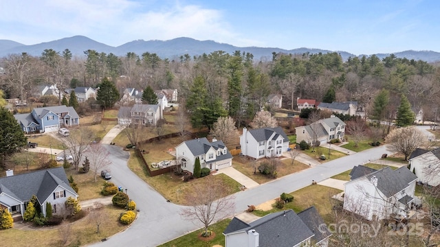 birds eye view of property with a mountain view and a residential view