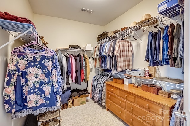 spacious closet featuring visible vents and carpet flooring