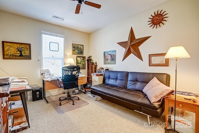 carpeted home office featuring a ceiling fan and visible vents