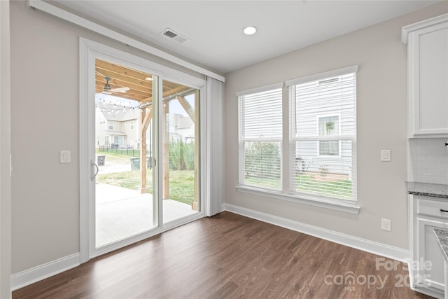 interior space with recessed lighting, visible vents, baseboards, and dark wood-style flooring