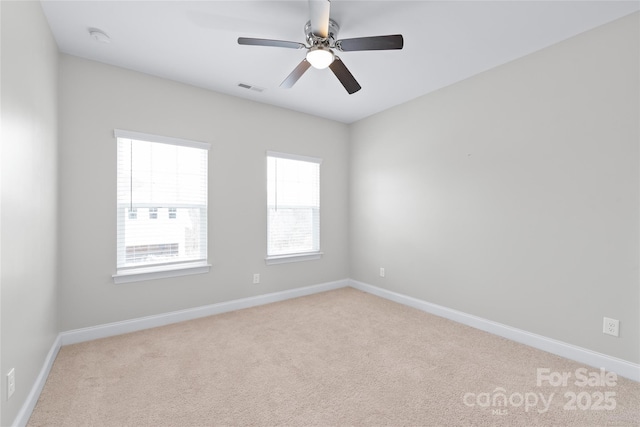 spare room with carpet flooring, baseboards, visible vents, and ceiling fan