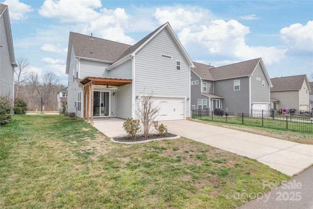 traditional-style home featuring a front lawn, fence, concrete driveway, a garage, and a patio