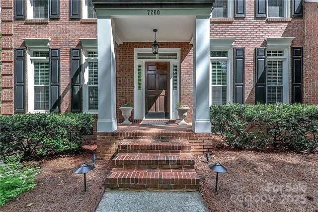 doorway to property with brick siding