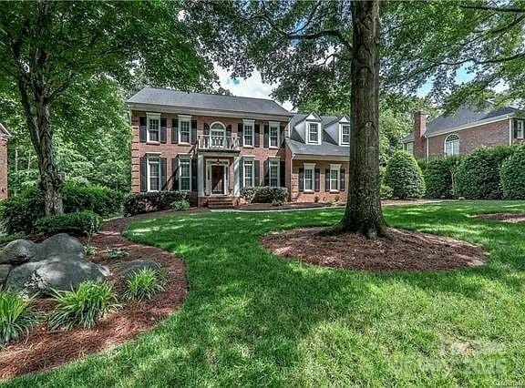 colonial inspired home with a front yard