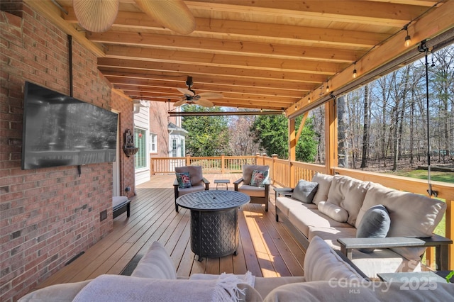 deck with an outdoor living space and ceiling fan