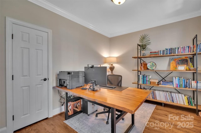 office space featuring crown molding, wood finished floors, and baseboards