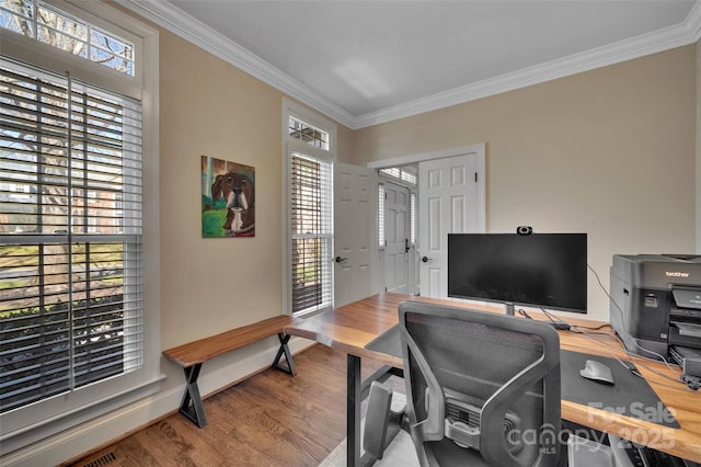 office area featuring crown molding, baseboards, and wood finished floors