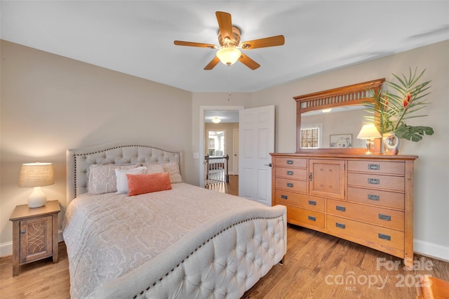 bedroom with light wood-type flooring, baseboards, and multiple windows