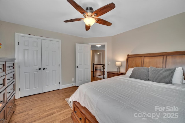 bedroom featuring a closet, baseboards, a ceiling fan, and light wood finished floors