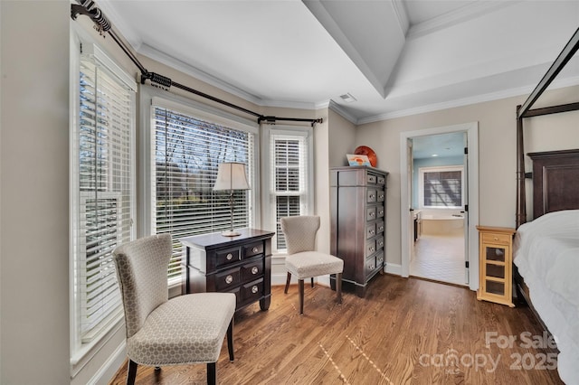 bedroom featuring crown molding, multiple windows, and wood finished floors