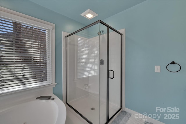 bathroom with a garden tub and a stall shower