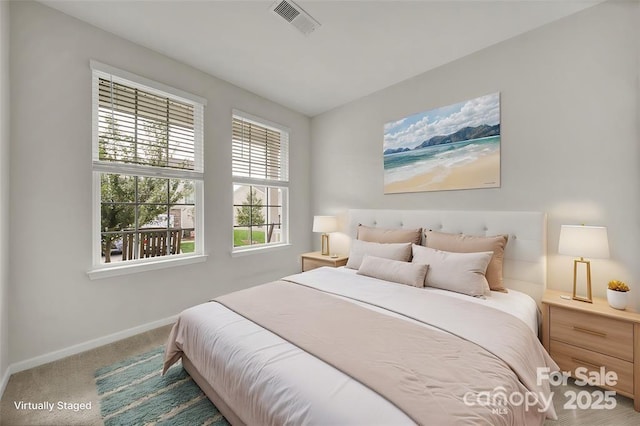 bedroom with carpet, visible vents, and baseboards