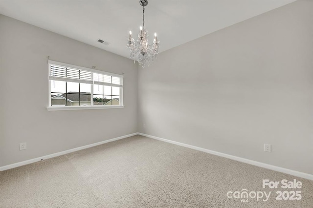 spare room featuring visible vents, baseboards, carpet, and an inviting chandelier