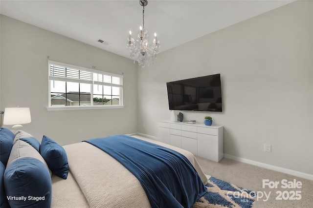 carpeted bedroom featuring visible vents, baseboards, and a notable chandelier