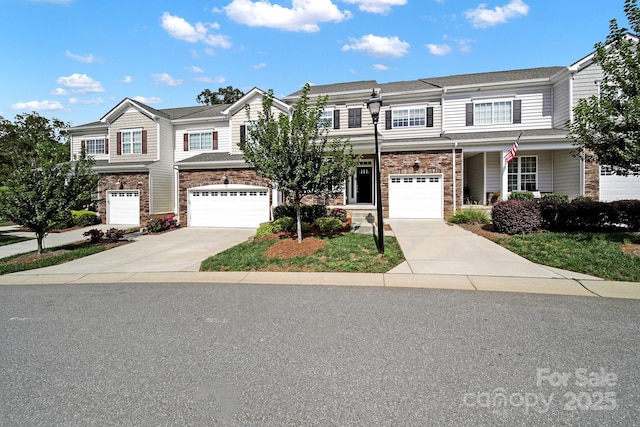 townhome / multi-family property featuring a garage and driveway