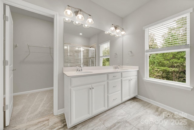 769 River Park Rd, Belmont, NC 28012 - full bathroom featuring a shower stall, double vanity, a walk in closet, and baseboards