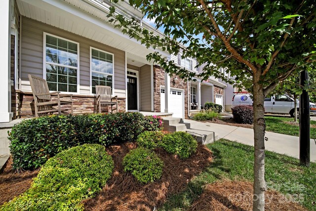 769 River Park Rd, Belmont, NC 28012 - view of front facade featuring covered porch, stone siding, and a garage