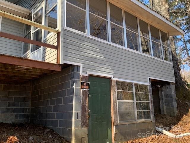 view of side of property with a sunroom