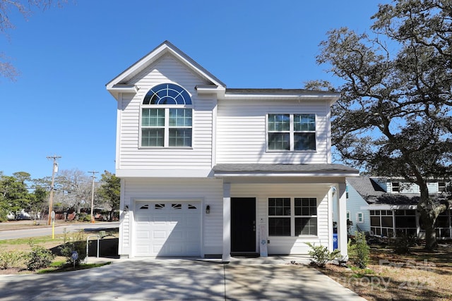 view of front facade featuring an attached garage, driveway, and a shingled roof